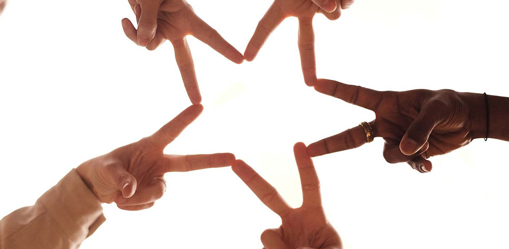 people forming star with hands