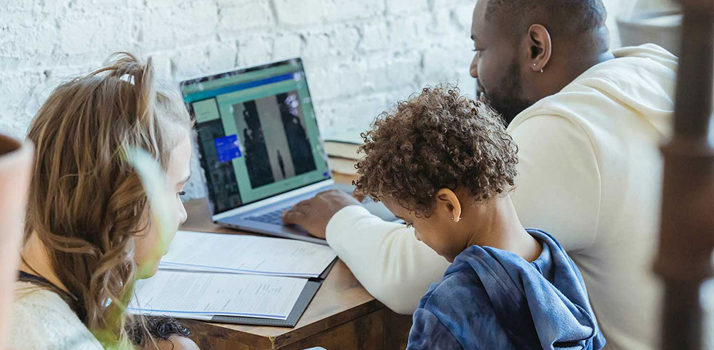 Family with dad working at desk